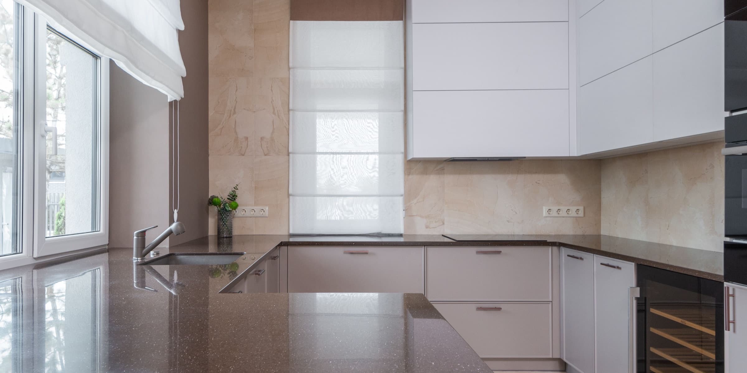 Stone kitchen countertop with sink and chrome tap